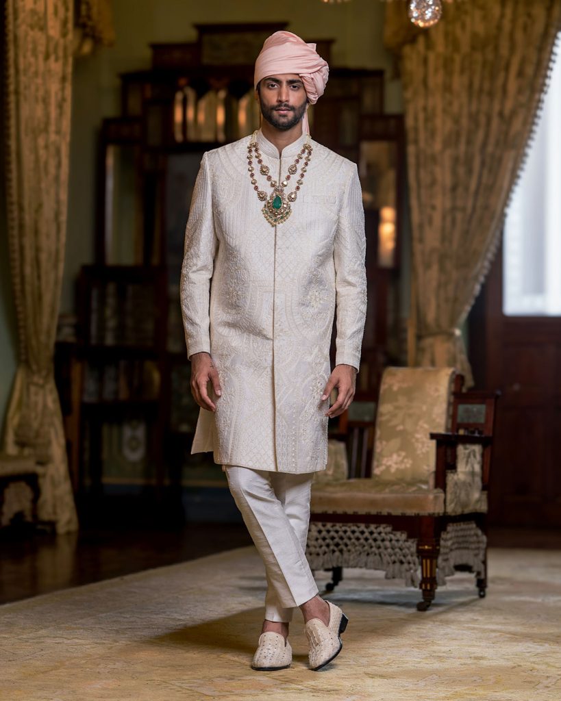 Groom in ivory embroidered Jodhpuri engagement outfit