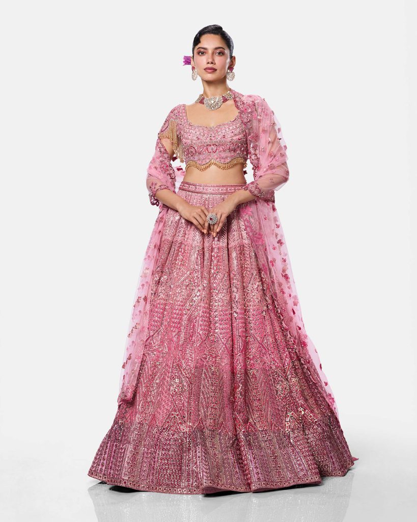 Pink embellished lehenga for an Indian engagement ceremony